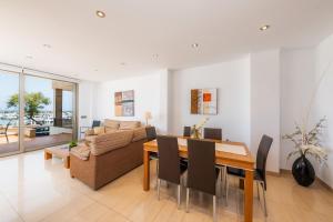 a living room with a table and a couch at Casa Mulet in Can Picafort