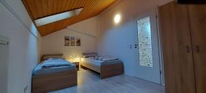 a room with two beds and a window in it at Ferienwohnung Meerblick in Wangerland