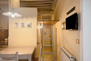 a room with a table and a tv and a hallway at Ca Lindaria in Bonassola