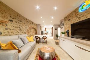 a living room with a couch and a table at Plaisir des pierres in Rivesaltes