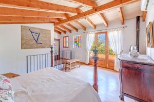 a bedroom with a bed and a wooden ceiling at Casa Catalina in Sóller