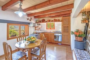 a kitchen with a table with a bowl of fruit on it at Casa Catalina in Sóller