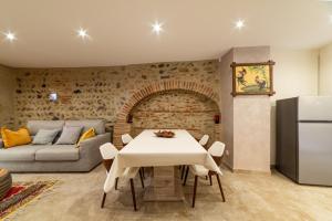 a living room with a white table and a couch at Plaisir des pierres in Rivesaltes