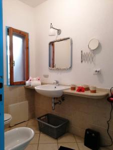 a bathroom with a sink and a mirror at Costa dei Monaci Villas - Tropea in Parghelia +32 photos