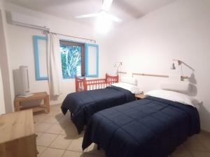 a bedroom with two beds and a window at Costa dei Monaci Villas - Tropea in Parghelia