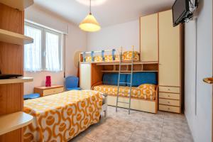 a bedroom with two bunk beds and a tv at Villa Minetta in Leporano Marina +19 photos