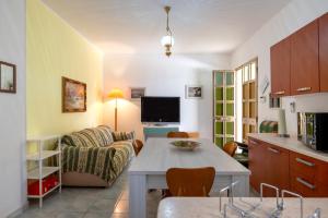 a living room with a couch and a table at Villa Minetta in Leporano Marina