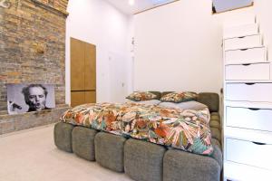 a bedroom with a bed and a brick wall at Gästehaus Achern in Achern
