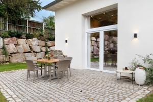 a patio with a table and chairs next to a building at Gästehaus Achern in Achern