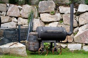 an old fashioned boiler and barrel sitting next to a stone wall at Gästehaus Achern in Achern