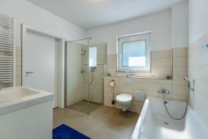 a bathroom with a shower and a toilet and a sink at Fewo Aida in Stockach +36 photos