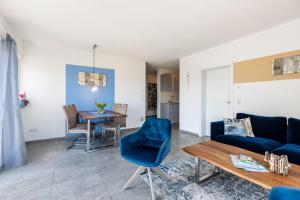 a living room with a blue couch and a table at Fewo Aida in Stockach