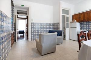 a kitchen with blue and white tiles on the walls at Sé Heritage in Angra do Heroísmo +29 photos
