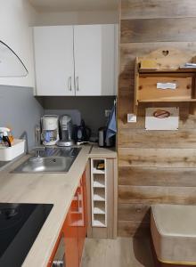 a kitchen with a sink and a counter top at Studio Fontanarosa centre station in Vars