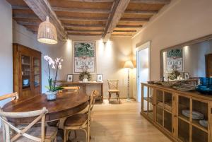 a dining room with a wooden table and chairs at Radicondoli House in Radicondoli