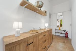a kitchen with a wooden counter with a lamp on it at Appartamento Matteo in Pula +38 photos