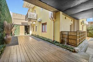 a house with a wooden walkway in front of it at Appartamento Matteo in Pula