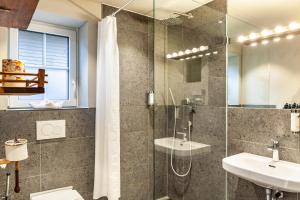 a bathroom with a glass shower and a sink at Chalet Rauschn 2 in Farchant +34 photos