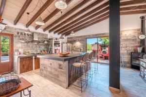 a kitchen with a large island with bar stools at Son French in Algaida