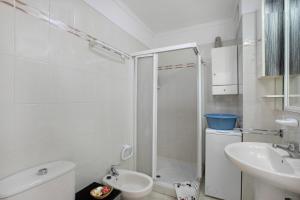 a bathroom with a shower and a toilet and a sink at Ceyla in Arona +14 photos