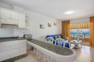 a kitchen and living room with a view of the ocean at Ceyla in Arona