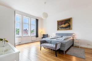 a bedroom with a bed and a table and a chair at Villa Elysium in Heide
