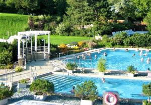 a large swimming pool with people in it at Ferienwohnung Hogh, 55qm, Terrasse in Beuren