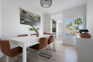 a white dining room with a white table and chairs at Casa Sol 21 A Garachico in Garachico