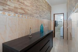 a bathroom with a counter with a blue vase on it at Casa Linda in Olhão +34 photos