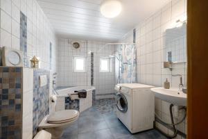 a bathroom with a washing machine and a sink at Ferienwohnung Wiesental in Meisburg +18 photos