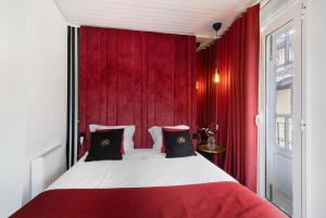 a bedroom with a large bed with red curtains at Prestigegoldresidence 2 - Old Town in Guimarães +13 photos