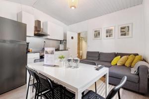 a living room with a white table and a couch at Prestigegoldresidence 2 - Old Town in Guimarães
