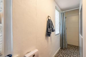 a bathroom with a towel hanging on the wall at Bungalow 145 in Zeulenroda +10 photos