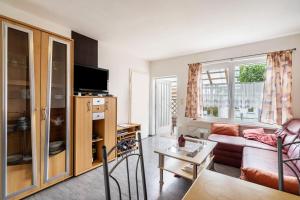 a living room with a couch and a table at Bungalow 145 in Zeulenroda