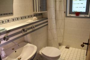 a bathroom with a toilet and a sink at Ferienhaus am Belmermoor 167 in Brunsbüttel +4 photos