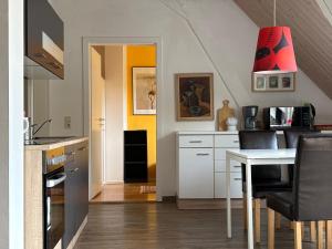 a kitchen with a table and a dining room at Ferienwohung Rotkehlchen in Kurort Gohrisch