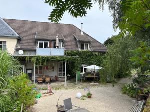 a house with a yard with a patio at Ferienwohung Rotkehlchen in Kurort Gohrisch