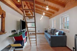 a living room with a loft bed and a couch at Dolomites Chalet Pian in Campitello di Fassa