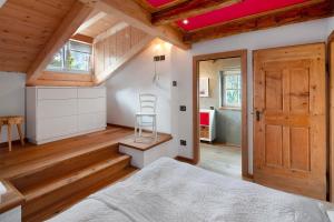 a bedroom with a bed and a wooden ceiling at Dolomites Chalet Pian in Campitello di Fassa