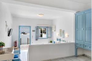 a kitchen with a blue cabinet and a sink at Pico Bello Patmos 10 in Patmos