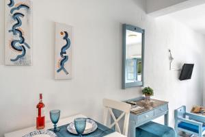 a dining room with a table and a mirror at Pico Bello Patmos 10 in Patmos +24 photos