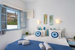 a bedroom with two beds and a window at Pico Bello Patmos 10 in Patmos