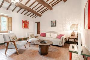 a living room with a couch and a table at Agriturismo Montechiaro in Siena +239 photos