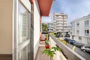 an apartment balcony with a view of a street at Matinhos House in Faro