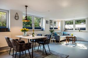 a living room with a table and chairs at Meerlust Travemünde in Travemünde