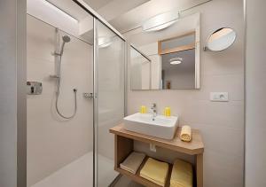 a bathroom with a sink and a shower at Wieser in Schenna +8 photos