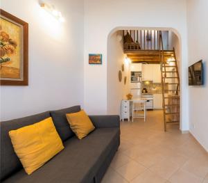 a living room with a couch and a kitchen at Casa 5 Flores in Odeceixe
