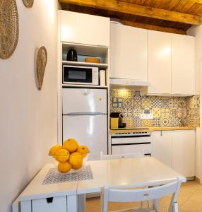 a kitchen with a white refrigerator and a table at Casa 5 Flores in Odeceixe +11 photos