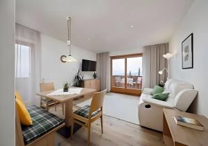 a living room with a table and a dining room at Wieser in Schenna