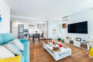 a living room with a blue couch and a table at Voramar in Pollença